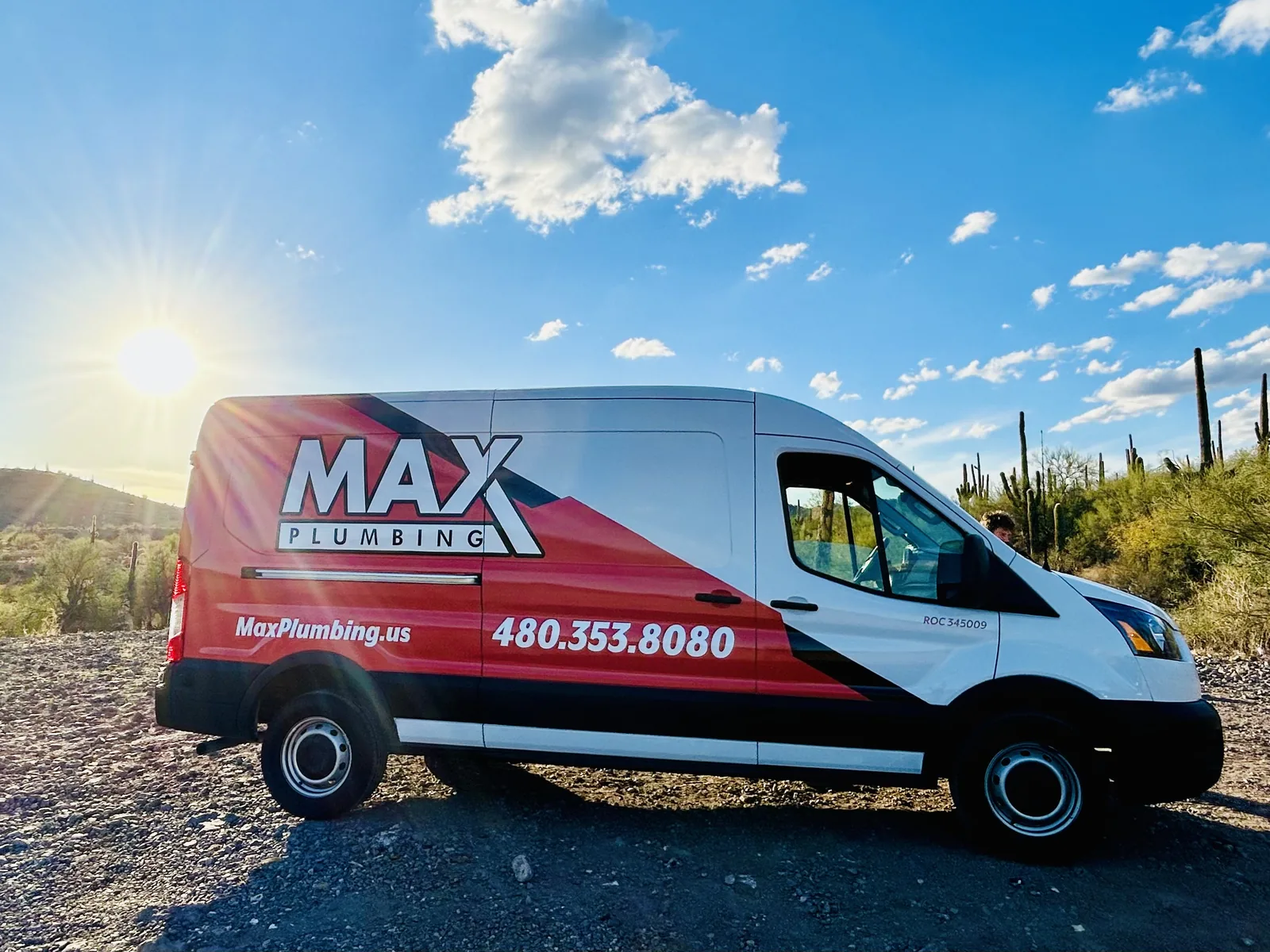 Max Plumbing service van with saguaros at sunset, ready for 24/7 emergency plumbing calls in the West Valley, AZ